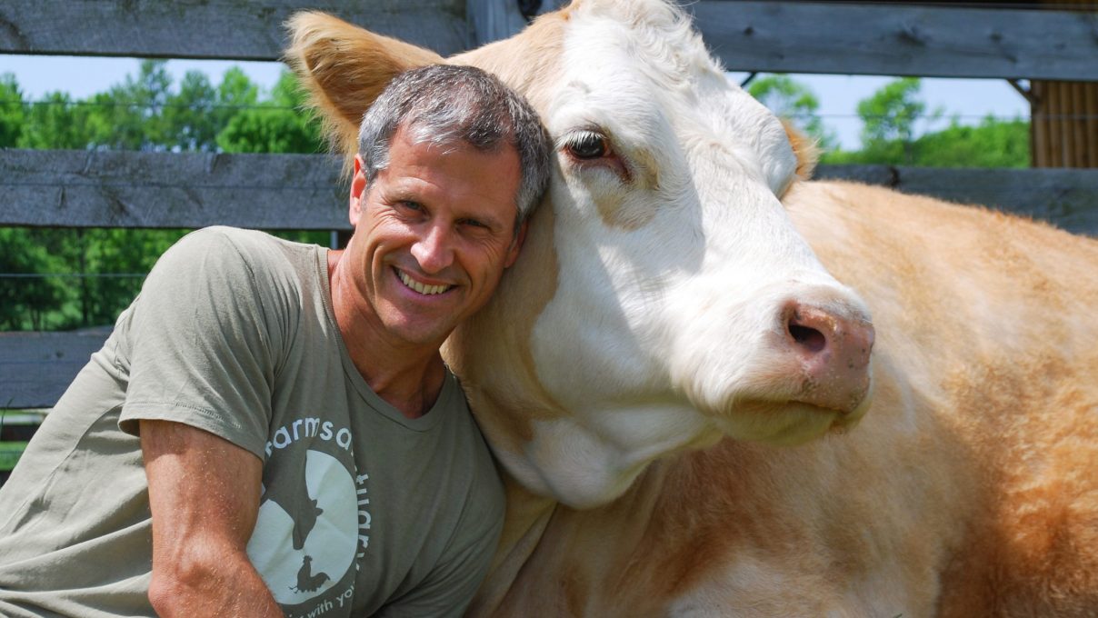 Farm Sanctuary President and Co-Founder Gene Baur with Meg cow
