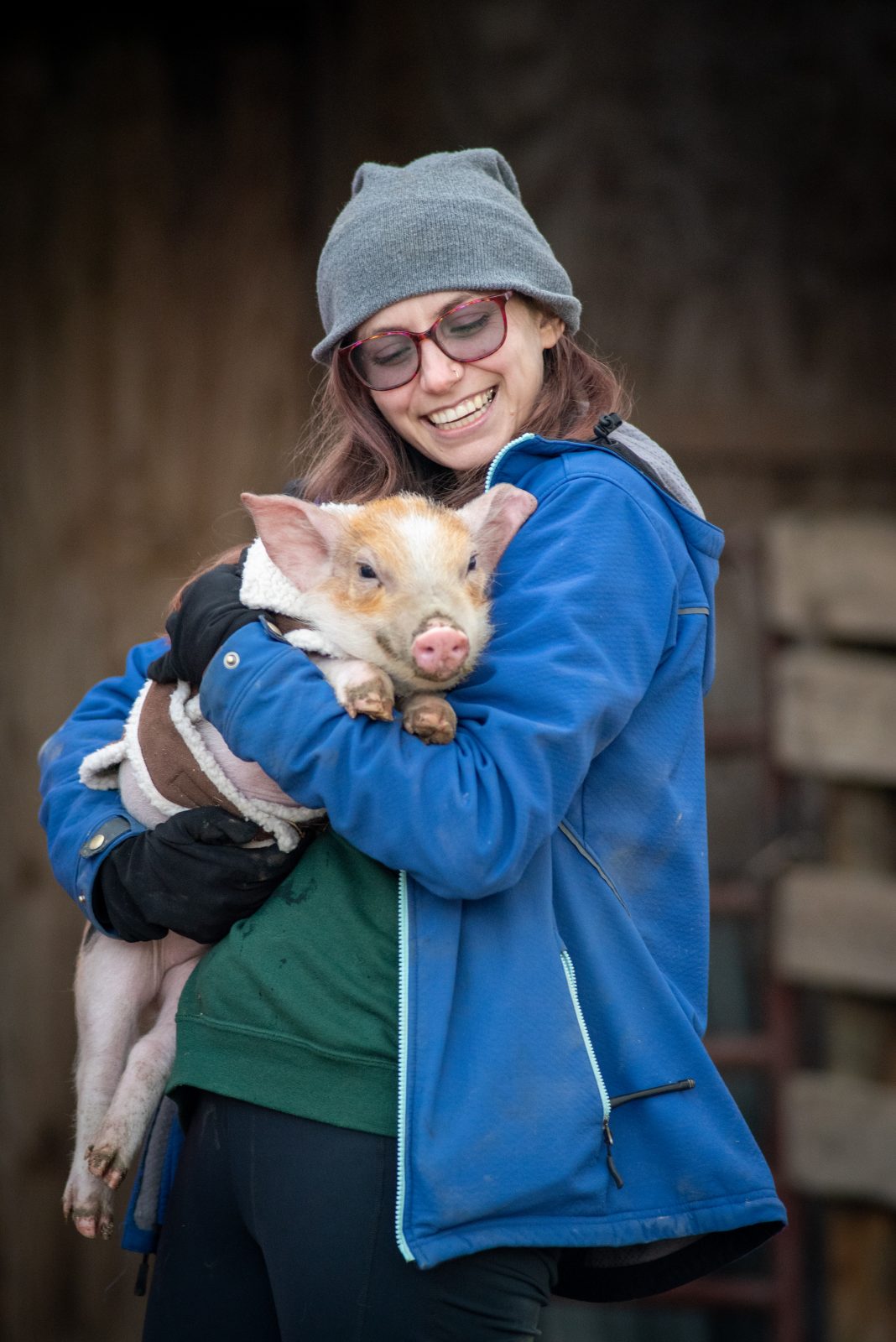 Caregiver Grace with George as a piglet at Farm Sanctuary
