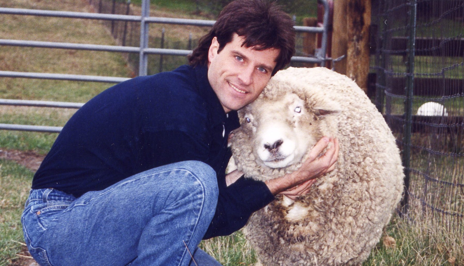 Gene Baur and Hilda sheep at Farm Sanctuary
