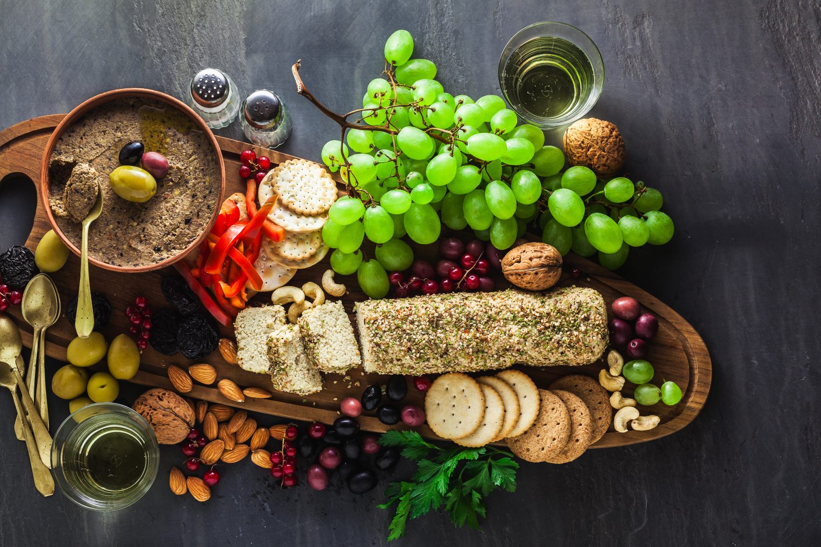 Wooden serving board with vegan snacks