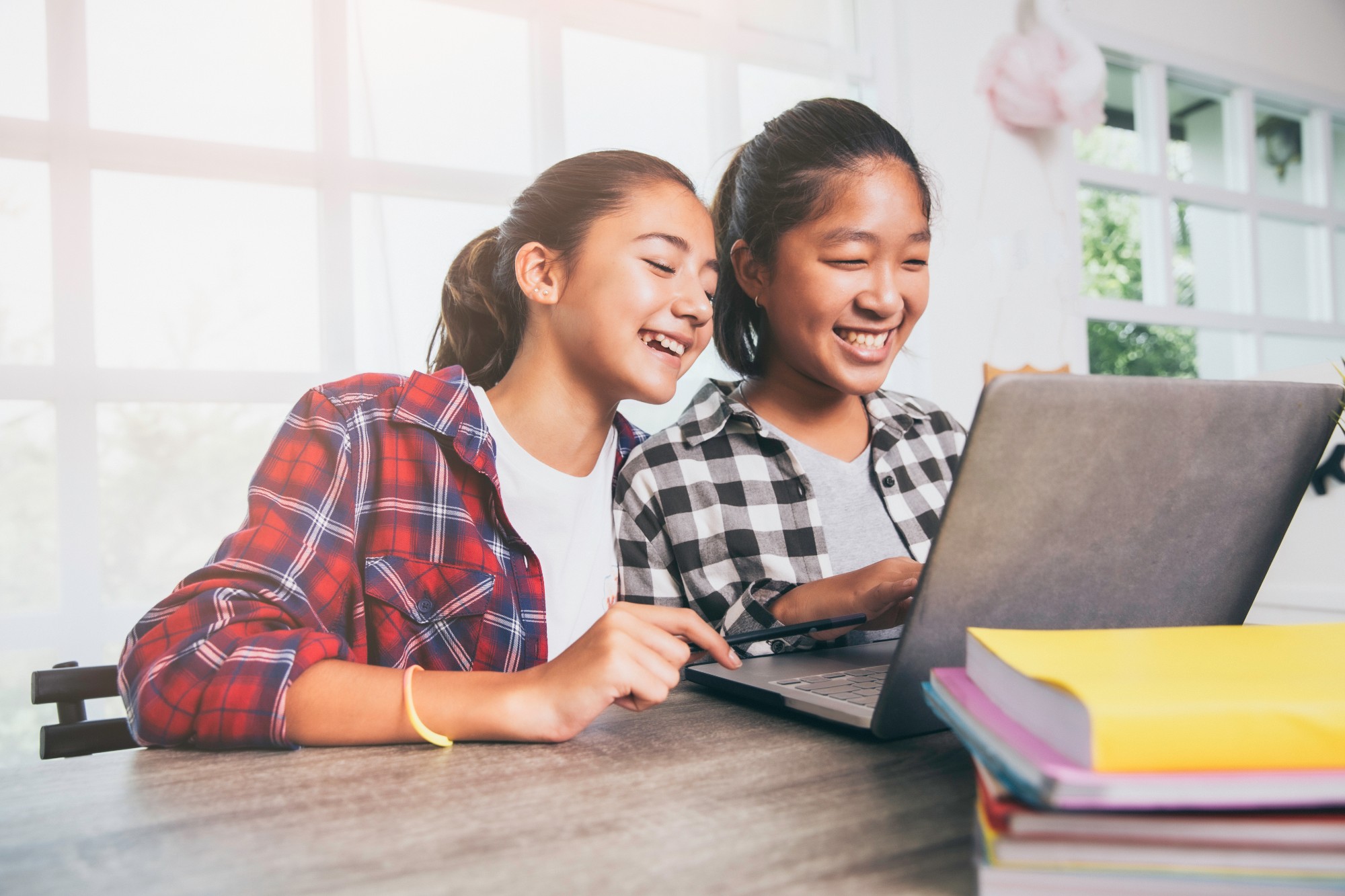 Two girls smiling looking at computer