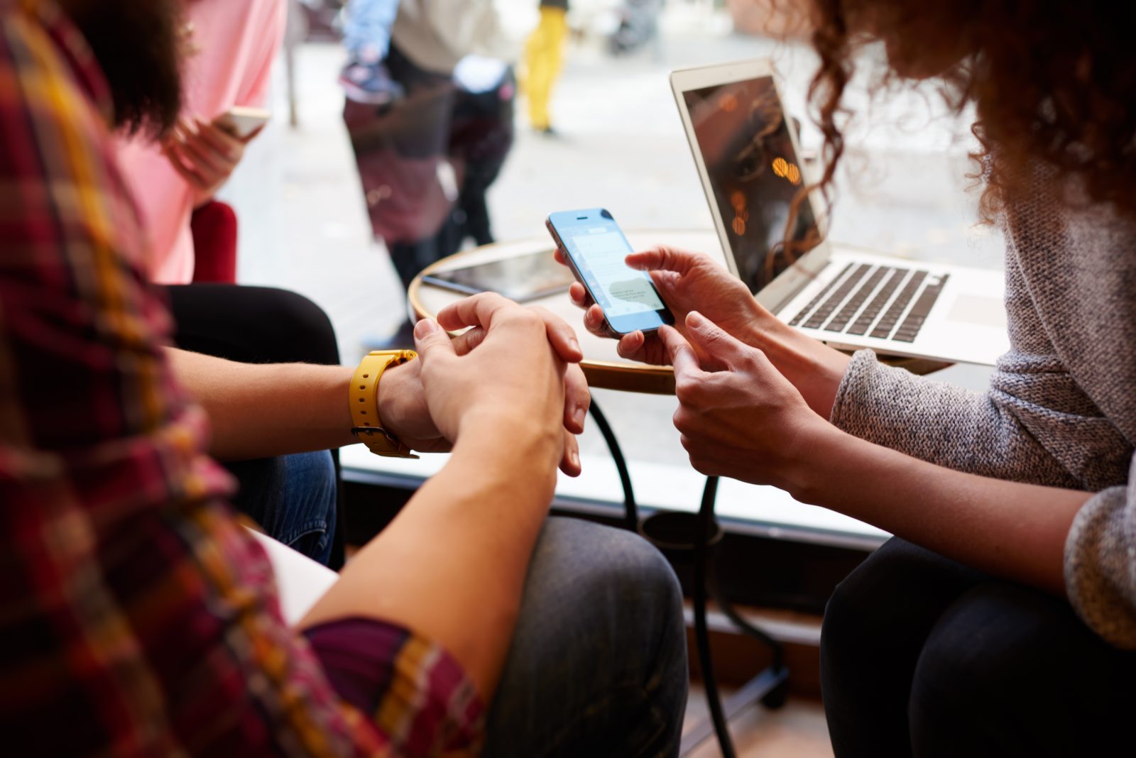 Two people look at a cell phone / Photo Credit: GaudiLab, Shutterstock