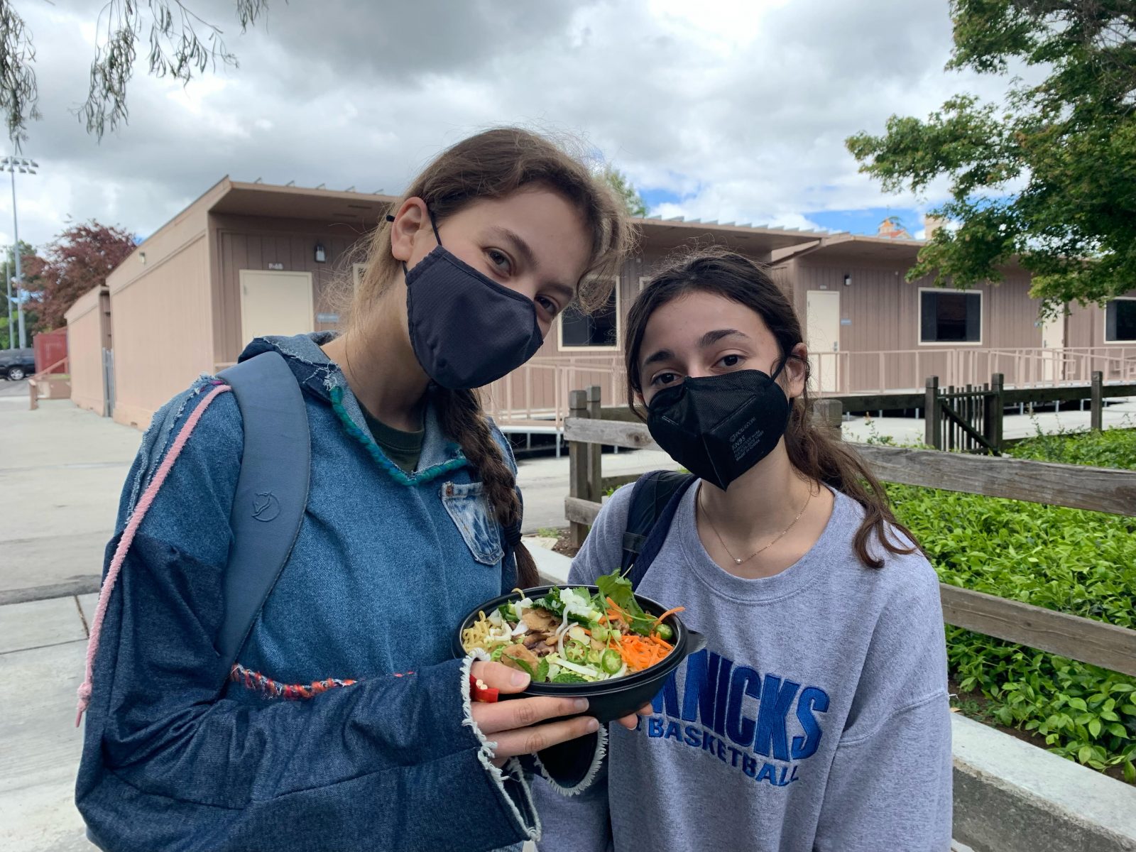 Morgan (left) and Margot (right) showcase a bowl of vegan pho