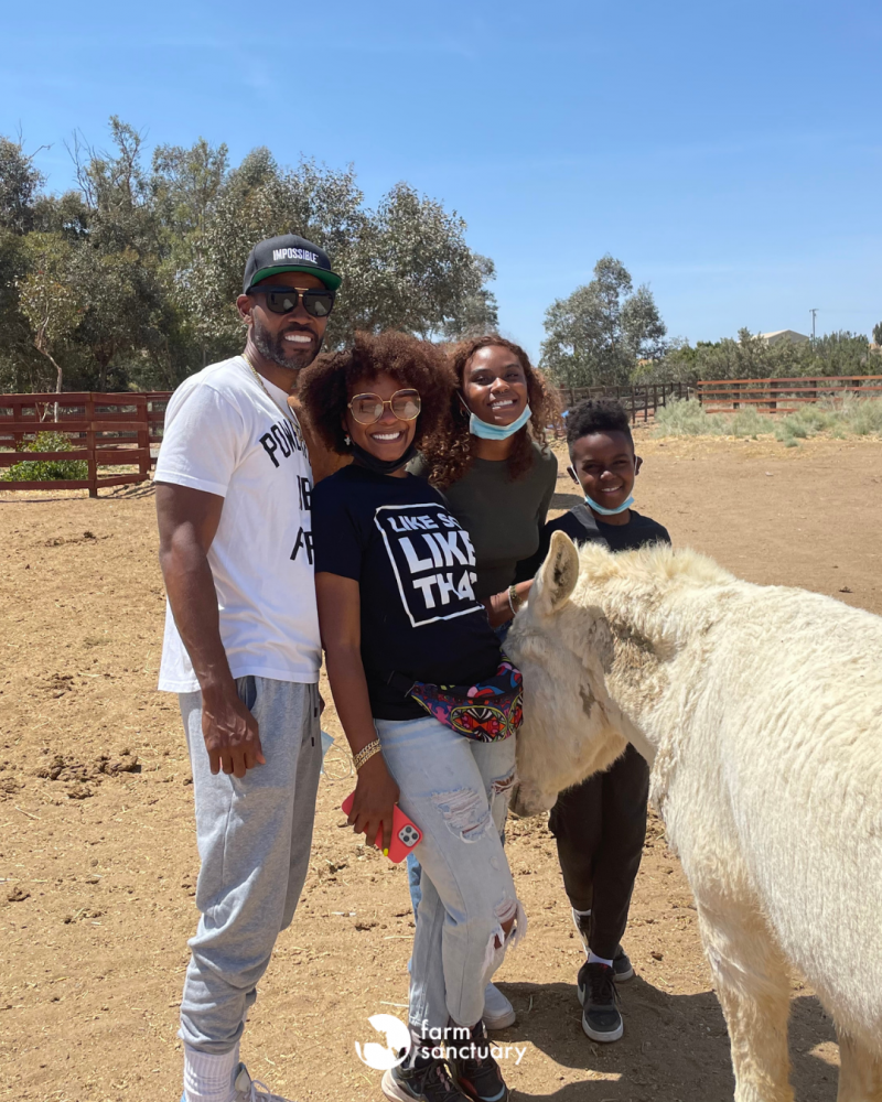 Tabitha Brown and family with Honkey Tonk Donkey at Farm Sanctuary