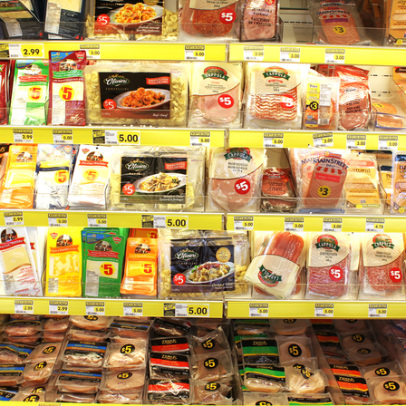 Variety of processed meats and prepacked foods in a grocery store